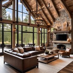 a living room filled with furniture and a fire place next to a stone wall covered in windows