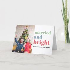 a christmas card with an image of two people in front of a tree and text that reads married and merry celebrating our first christmas together