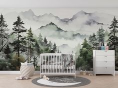 a baby's room with a mountain mural and crib in the foreground