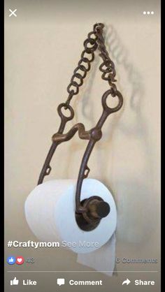 a roll of toilet paper hanging from a chain