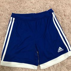 Royal Blue Clima Cool Adidas Shorts With Stripes On The Sides And Draw String Tie Front Casual Adidas Blue Athletic Shorts, Casual Blue Adidas Athletic Shorts, Blue Sports Shorts With Three Stripes, Blue Athletic Shorts With Three Stripes For Sports, Adidas Blue Shorts With Three Stripes, Adidas Blue Sports Bottoms, Adidas Blue Athletic Shorts For Sports, Blue Sporty Athletic Shorts With Three Stripes, Blue Striped Sporty Athletic Shorts