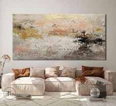 a living room with a large painting on the wall