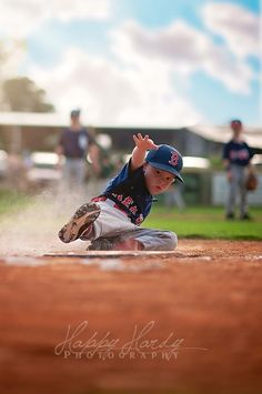 a young baseball player sliding into home plate