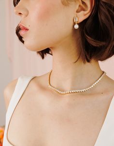 Introducing our Queen's Heart Tennis Necklace, the perfect way to add a little romance to your style! Featuring a row of heart-shaped stones set in a delicate 14k gold-plated design, this necklace brings a touch of royal charm to any outfit. Ideal for casual days, date nights, or glamorous evenings, the Queen's Heart Necklace makes every look feel extra special. It's a chic and versatile piece you'll reach for time and time again! NECKLACE FEATURES Material: Brass, White Cubic Zirconia Dimension Elegant Yellow Gold Necklace With Sparkling Stones, Dainty Gold Plated Diamond Necklace For Wedding, Gold Tennis Necklace With Clavicle Chain, Feminine Yellow Gold Necklace For Anniversary, Elegant Gold Heart Cut Diamond Necklace, Elegant Gold Diamond Heart Cut Necklace, Chic Jewelry For Wedding And Valentine's Day, Chic Wedding Jewelry For Valentine's Day, Formal Heart Cut Necklaces