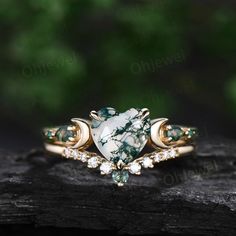 This is a natural moss agate engagement ring in solid gold,about 7mm heart.  The accent stones are pear moss agates and lab emeralds.. The wedding band stones are moissanites and moss agate. The band width is about 1.3-1.4mm. It can be made in any ring size. However please contact me to custom make it to a special big or small size. It can be made in white gold,rose gold or yellow gold with 14k or 18k. However for some people who are nickel allergic,I can also make it to 925 sterling silver to m Three Stone Pear-shaped Jewelry Gift, Pear-shaped Three Stone Jewelry Gift, Emerald Anniversary, Rutilated Quartz Ring, Agate Engagement Ring, Moss Agate Ring, Rose Quartz Ring, Engagement Rings Platinum, Gold Moon