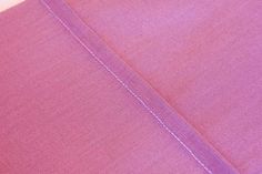 closeup of the stitching on an unbuttoned piece of clothing fabric