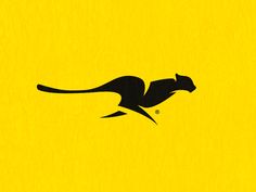 a black cat is running on a yellow background with an orange spot in the middle