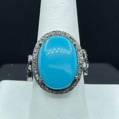 This Is A Beautiful Natural Turquoise And Diamond Ring Set In Sterling Silver. This Ring Features A Beautiful Turquoise That Measures 11.31 Carats In Size As Well As 0.63 Carats Of Diamonds. The Ring Weighs 7.1 Grams And The Deck Of The Ring Measures 17.80 X 16 Mm. This Turquoise Originated In Arizona And The Ring Is Size 8.5. Turquoise Promotes Self-Realisation And Assists Creative Problem Solving. It Is A Symbol Of Friendship, And Stimulates Romantic Love. Turquoise Is The Gemstone Associated With December. This Ring Is Handmade And One Of A Kind. Oval Turquoise Ring With Diamond Accents, Luxury Blue Turquoise Ring For Formal Occasions, Elegant Blue Turquoise Ring With Center Stone, Turquoise Blue Diamond Ring With Center Stone, Formal Fine Jewelry Turquoise Ring With Accent Stones, Blue Turquoise Ring With Diamond Accents For Wedding, Formal Turquoise Ring With Accent Stones, Formal Blue Oval Turquoise Ring, Formal Turquoise Multi-stone Rings