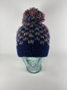 This hat is just GOOD Fun!  The design is a bit classic yet with a twist of rainbows.  The navy blue yarn is a blend of acrylic for comfort with just a bit of alpaca that creates a very soft texture.  The "angel hair" rainbow yarn is also a blend of acrylic and wool that creates almost electric rainbow checks against the luscious navy blue.  And finally, I embellished this hat with a very cool oversized hand made rainbow pom pom.   This hat is perfect for mountain wear, city streets or even your next outdoor festival.  And I knit in a pet and smoke free environment too! Easy care of hand washing in cool water and then just dry flat.  Look for matching or coordinating accessories in my VoodooKnitter Etsy Store...with FREE shipping! Rainbow Pom Pom, Mountain Wear, Hair Rainbow, Rainbow Yarn, Outdoor Festival, Knit Pom Pom Hat, Knit Pom Pom, Angel Hair, Pom Pom Hat