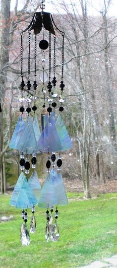 a wind chime hanging from the side of a tree