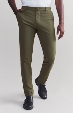 A flat front and modern slim fit take you anywhere in comfortable four-way-stretch pants fitted with secure hidden pockets for your phone, currency or keys 32 1/2" inseam; 13" leg opening; 12" front rise; 14 1/2" back rise (size 32) Zip fly with snap closure Front slant pockets; back welt pockets; front zip pockets 100% polyester or 57% recycled polyester, 43% elastimultiester Machine wash, tumble dry Imported Green Slim Fit Pants With Pockets, Green Pull-on Straight Pants, Green Pants With 4-way Stretch And Pockets, Slim Fit Pants, Stretch Pants, Workout Pants, Welt Pocket, Zip Pockets, Nordstrom