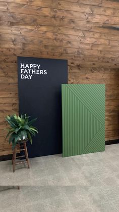 two green panels next to each other in front of a wooden wall with the words happy fathers day written on it