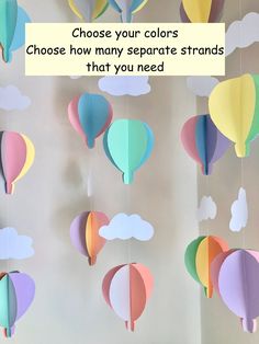 paper hot air balloons are hanging from the ceiling with clouds in the background and text that reads choose your colors