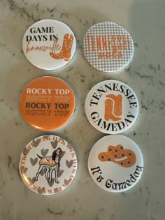 four pinback buttons that say rock'n'roll, tennessee, tennessee and tennessee