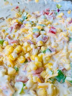 a mixture of corn and cheese in a glass bowl