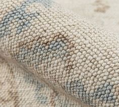 close up view of the texture of a rug with blue and white patterns on it