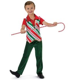 a young boy holding a candy cane in one hand and pulling it with his other