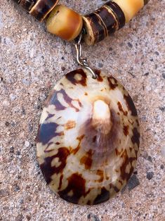 Coconut shell beads African amber beads (resin, we believe) Old silver bench beads, Native 2 strands Limpet shell pendant Secure hook clasp Light but substantial on Unisex Stamp: none, artisan Native made 20210710J1068 Provenance: mid1980s Condition: Excellent vintage condition. No issues of note. See pics. Sold as is. Measurements: Total length 17.25inches (43.81cm) Size of limpet shell itself 2 x 1.5inches (5.08 x 3.81cm) Drop 4.75inches (12.06cm) Check measurements and/or convo with ANY quest Beach Shell Jewelry With Large Beads, Beach Jewelry With Large Shell Beads, Adjustable Large Beaded Shell Jewelry, Brown Beaded Shell-shaped Jewelry, Bohemian Shell Jewelry With Large Beads, Shell-shaped Beaded Necklaces For Jewelry Making, Brown Beaded Shell Jewelry, Brown Beaded Shell Necklace, Shell Necklace For Jewelry Making