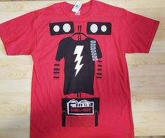 a red t - shirt with an image of a robot on it