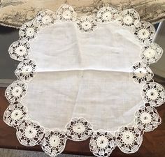 a white doily on top of a wooden table