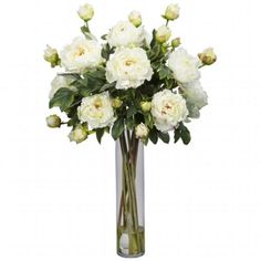 a vase filled with white flowers on top of a table