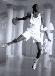 a basketball player is jumping in the air with a ball