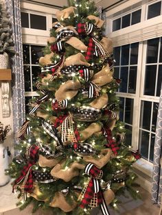 a christmas tree decorated with burlocks and bows