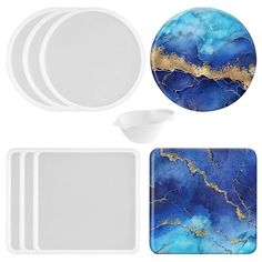 the blue and gold marble dinnerware set includes plates, bowls, and spoons