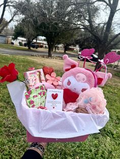 a pink basket filled with lots of valentine's day items