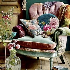 a chair with pillows and flowers on it