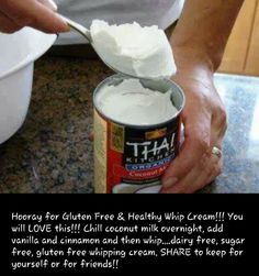 a person holding a spoon full of whipped cream over a can of cake mix on a counter