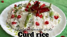 a white plate topped with rice and pomegranates on top of a green table