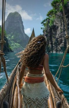 a woman in a white dress riding on top of a wooden boat next to the ocean