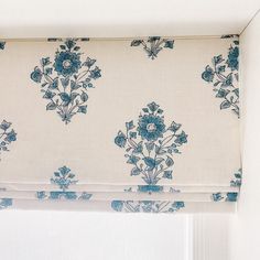 a blue and white floral print roman blind