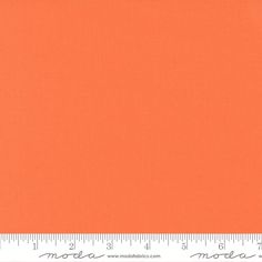 an orange background with a ruler in the foreground