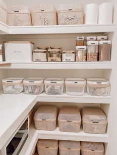 an organized pantry with white shelves and baskets