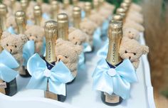 there are many teddy bears with champagne bottles in the shape of shoes on top of them