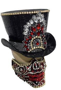 This is limited edition 2 pcs set Top hat and half face mask by SteamEra Production Hand made Black sequins burlesque look Top Hat with hand stitched jewels details at front with black and white stones at the base of hat ribbon. Mask has 2 adjustable straps, it has a 4 buckles and can be tightened to adjust to most heads and inside is fully lined and has sponges for comfortable fit.  please refer to photos. This is hand made and it is very well made. This hat is made of black sequences Fabric and inside of the hat is fully lined. The front of hat and mask has Brass look diamanté edging all around the details. This Top hat  has lots of details please refer to photos. SIze Available 55cm Mask is available in one size only . Thank you for looking Adjustable Costume Masks For Carnival, Fitted Costume Hats For Carnival Masquerade, Carnival Adjustable Top Hat With High Crown, Adjustable High Crown Top Hat For Carnival, Fitted Masquerade Costume Hats For Carnival, Fitted Costume Hats And Headpieces For Carnival, High Crown Top Hat For Carnival, Sequence Fabric, Alice In Wonderland Props