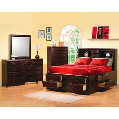 a bedroom scene with focus on the bed and dressers, mirror and nightstand unit