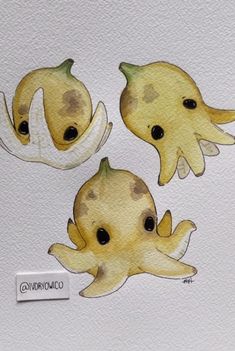 three stickers with different shapes and sizes of squids in watercolor on white paper