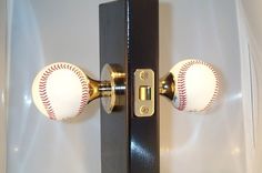 two baseballs are mounted to the back of a door