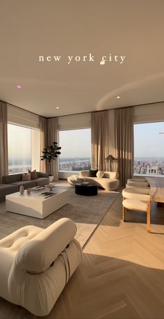 a living room filled with white furniture and large windows overlooking the cityscape in new york city