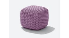 a purple poufce sitting on top of a white floor