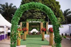 an outdoor wedding setup with flowers and greenery