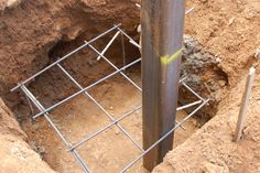 a hole in the ground that has been dug into by metal bars and steel posts