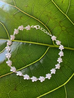 "6MM PLUMERIA STERLING SILVER BRACELET This genuine 925 sterling silver bracelet features the plumeria flower. Plumeria, in Hawaiian culture symbolizes beauty, charm, grace, and new beginnings, or re-birth. It is one of the most popular flowers on the Hawaiian Islands and widely used in lei making and jewelry designs. Makes a great gift or addition to your Hawaiian jewelry collection. Material: 925 STERLING SILVER Length available: 7\" or 7.5\" Diameter of Flower: 6mm Closure: Lobster Clasp Quan Flower Plumeria, Lei Making, Most Popular Flowers, Puka Shell Necklace, Popular Flowers, Hawaiian Culture, Hawaiian Jewelry, Cz Bracelet, Puka Shell