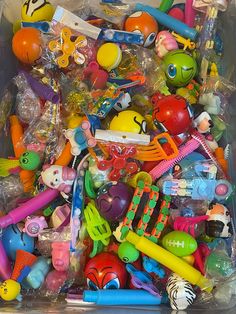 a plastic container filled with lots of different types of toys and items to play with