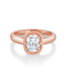 a rose gold ring with a cushion cut diamond