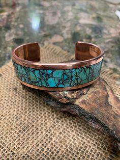 *  King Man Turquoise Inlay. Black Matrix light blue. *  Milled Solid Copper. * 0.75" Wide. 3 mm Thickness. 0.5" Wide is available on the option. *  Polished and Waxed. *  Blue  and Black Matrix Turquoise.  Mark your color on the option. * Made to order. Measure your whole wrist tightly on the wrist bone and mark it on the option. Turquoise Cuff Bracelet With Polished Finish, Artisan Round Turquoise Cuff Bracelet, Artisan Blue Cuff Bangle Bracelet, Artisan Blue Bangle Cuff Bracelet, Blue Polished Bangle Cuff Bracelet, Artisan Handmade Blue Bangle, Artisan Turquoise Round Bracelet, Turquoise Patina Cuff Bracelet As A Gift, Turquoise Cuff Bracelet With Patina As A Gift