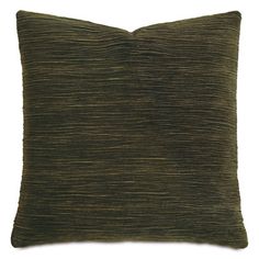 a dark green pillow on a white background